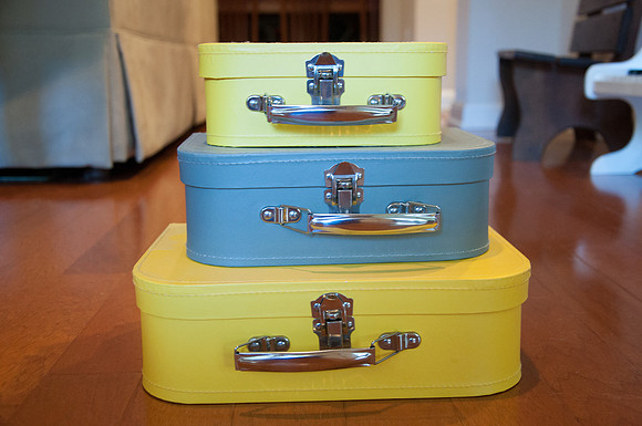 3 yellow and gray suitcases